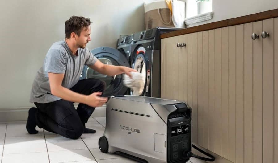 A man doing laundry with a portable power station