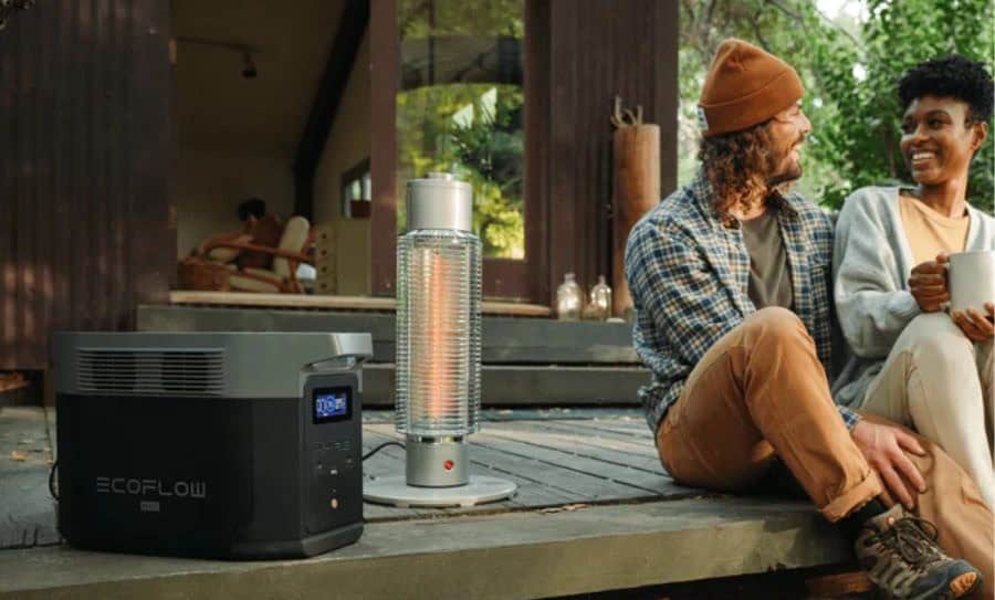 Two people on a porch with a portable heater and a power station