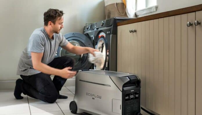 A man using washing machine with EcoFlow power station