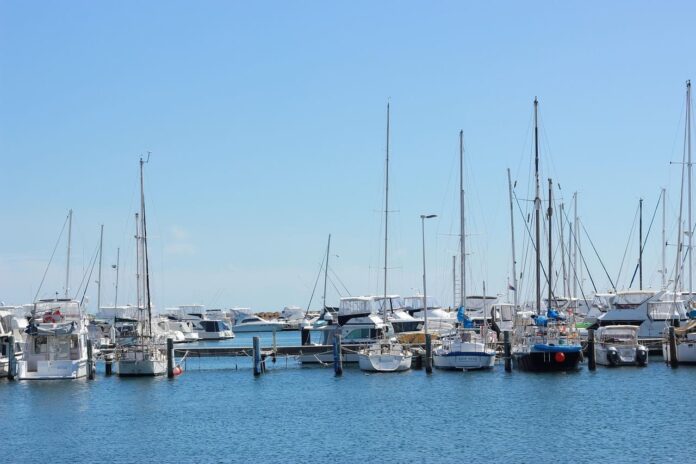 A marina with several boats and yachts docked