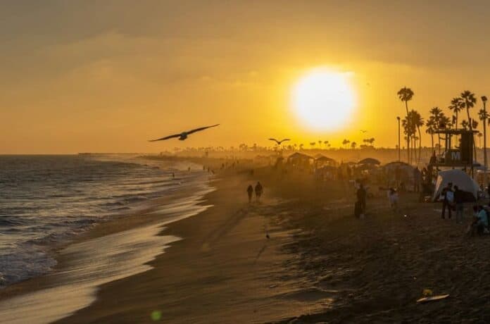 Golden sunset over a crowded beach