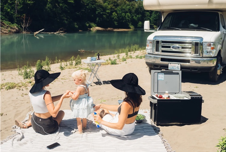 A family enjoying a picnic by a river