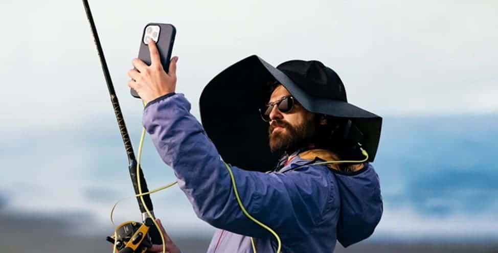 A man in the EcoFlow power hat takes a selfie while fishing