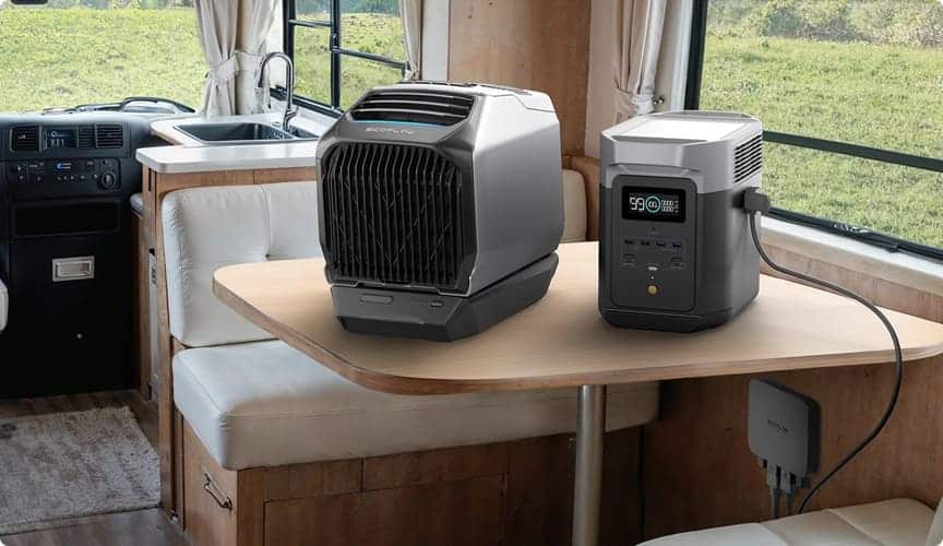 EcoFlow portable power station and air conditioning unit placed on a wooden table inside an RV