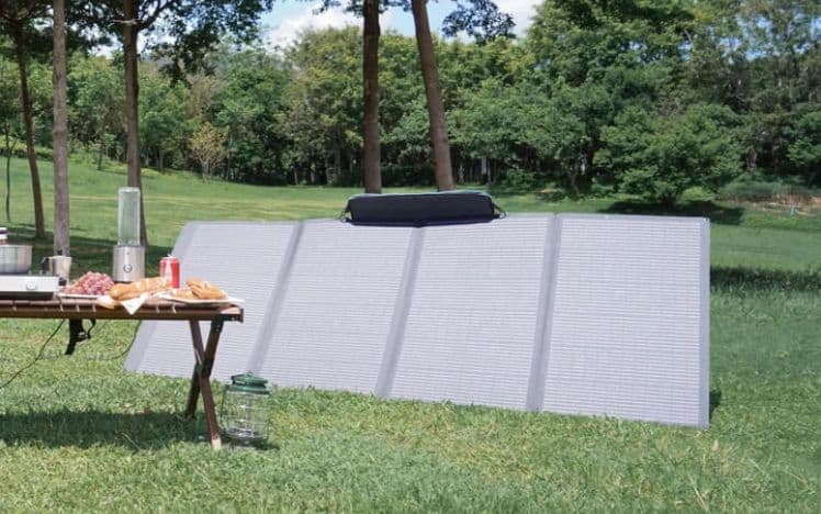 Solar panel on grass next to a picnic table