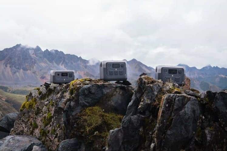 Three portable power stations placed on rugged mountain rocks