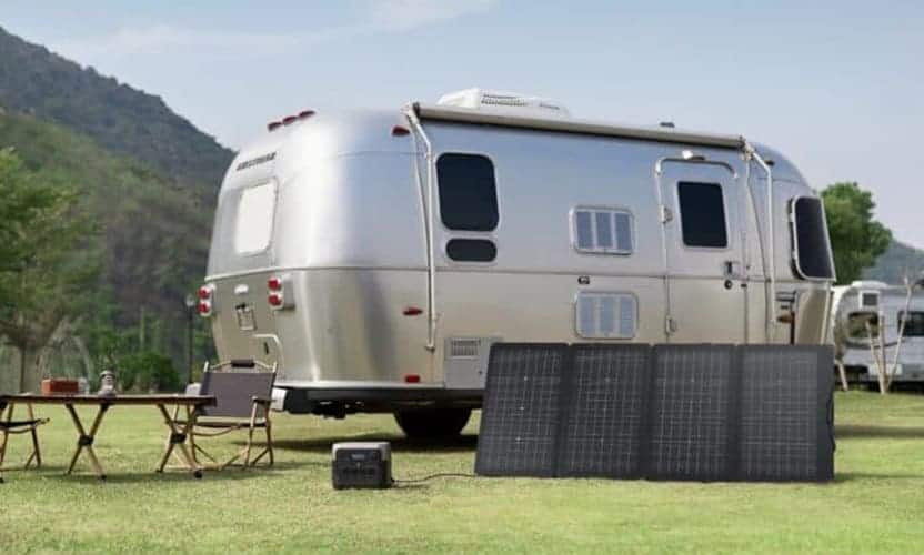 Trailer parked on grass with EcoFlow solar panels and portable power station