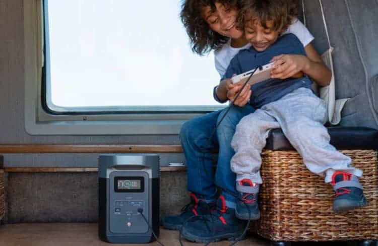 Two children play a gaming console powered by an EcoFlow portable power station